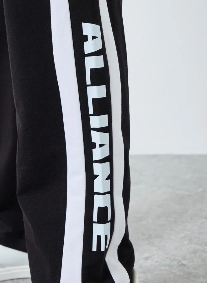 Styli Men Oversized Terry Side Tape Printed Joggers